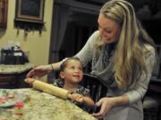 Aliyah and Gwen Bumala prepare for Thanksgiving by baking sugar cookies and treats Tuesday at their home near Washougal. Born to methamphetamine-addicted parents, Aliyah, 2, was adopted out of the foster care system by the Bumalas this summer, making this her first Thanksgiving with the family.