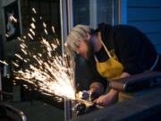 Ken Tucker works on shaping a dagger from a recycled sword that broke.