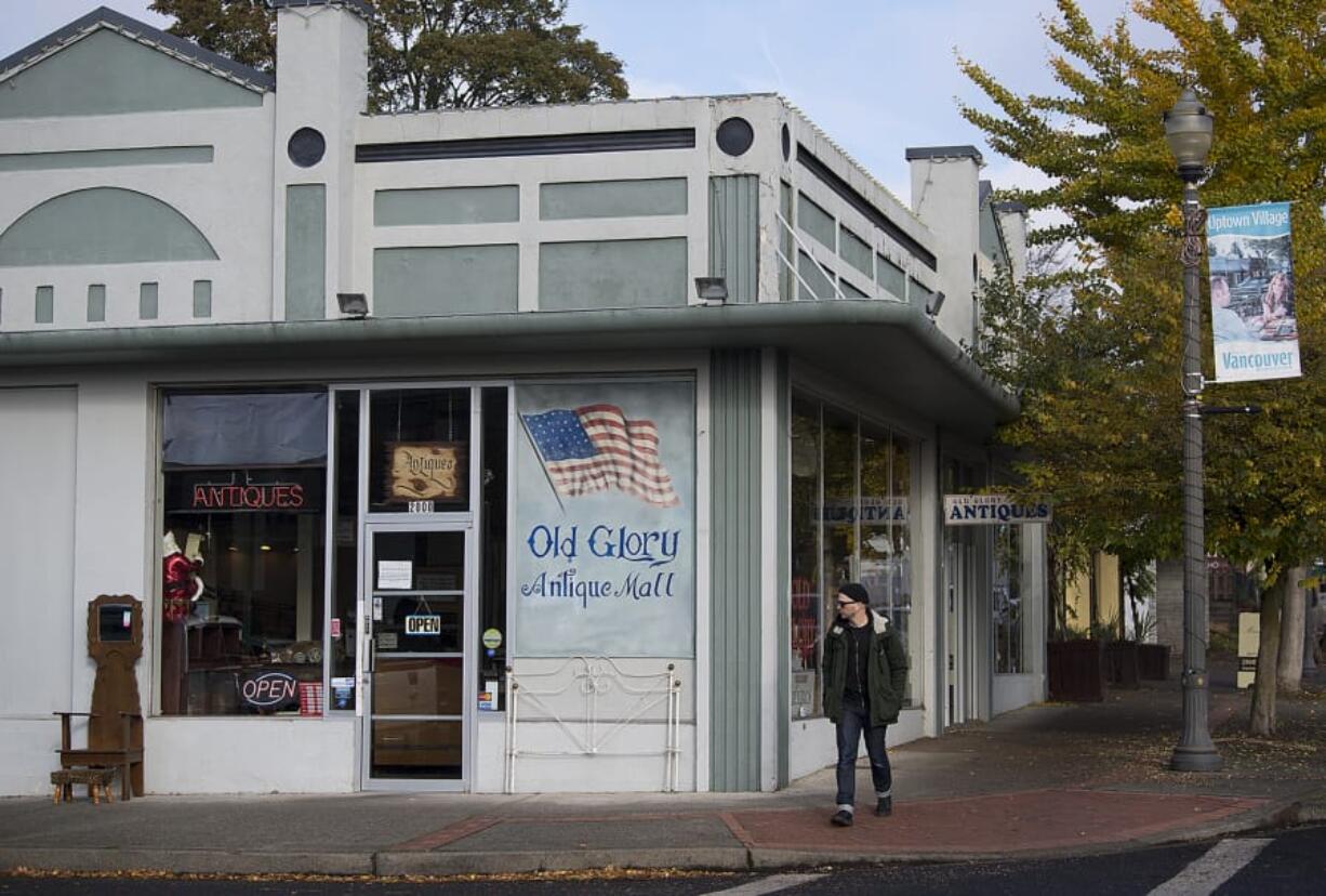 Patrick Porter of Vancouver strolls past Old Glory Antique Mall in Uptown Village. The longtime retail location, with up to 50 vendors, recently changed ownership.