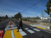 Heidi Rosenberg, director of capital programs for the Camas School District, uses a new crosswalk to cross Northwest 18th Avenue across from Discovery High School in Camas.