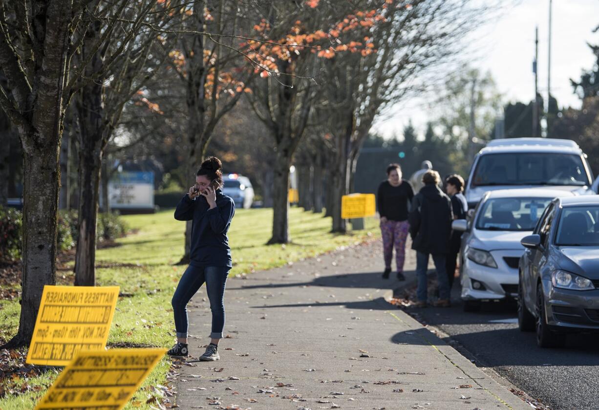 Jenessa Lindsey of Vancouver talks with her younger sister inside Heritage High School as she waits outside during the  modified lockdown on Friday afternoon, Nov. 16, 2018. "I think that's the most panicked call I've ever had to make in my life," she said.