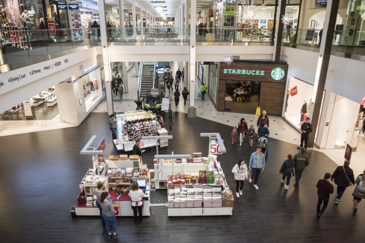 Shoppers move through the Vancouver Mall looking for Black Friday sales Friday morning. Despite some ebbs in foot traffic, mall operators described business as fairly consistent throughout the day, and likely on par with the year before.