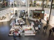 Shoppers move through the Vancouver Mall looking for Black Friday sales Friday morning. Despite some ebbs in foot traffic, mall operators described business as fairly consistent throughout the day, and likely on par with the year before.