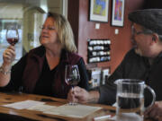 Jeanette, left, and Mike Riopelle savor a newly released wine at Burnt Bridge Cellars in Vancouver on Saturday. The winery particpated in the annual Thanksgiving Barrel Tasting and Fall Release Wines Tour. The event continues today.