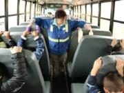 Battle Ground: Helen Peterson checks on Glenwood Heights Primary School students who are practicing earthquake safety.