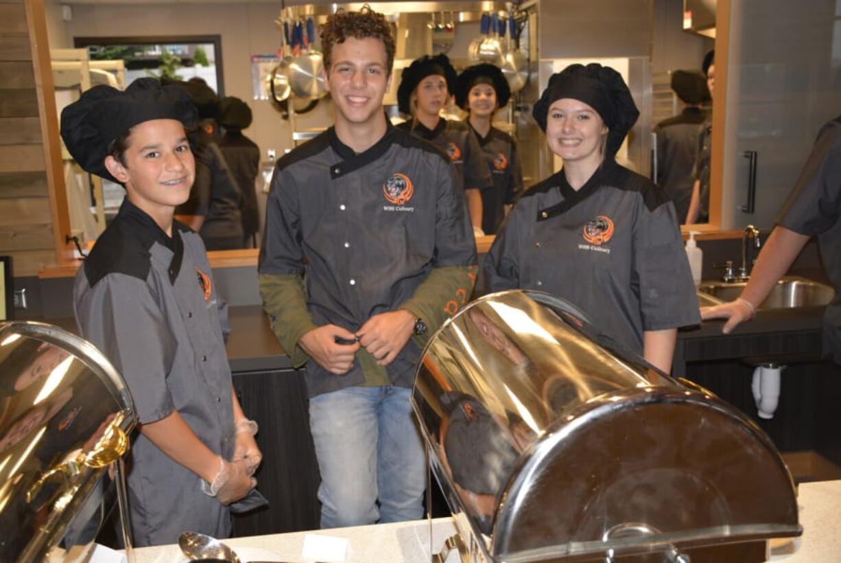 Washougal: Zachariah Schroeder, from left, Michael Gonser and Paige Limbo with Washougal High School’s culinary program at a night celebrating the district’s Career and Technical Education program.