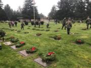 Members of the Lewis and Clark Young Marines place wreaths at the graves of veterans in the Evergreen Memorial Gardens during the 2017 Wreaths Across America ceremony. With around 70 members, Lewis and Clark Young Marines is among the largest and most active Young Marines chapters in the nation.