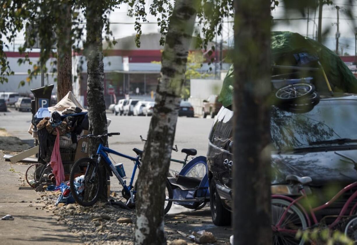 Bikes and belongings sit next to a van near Share House in Vancouver on Monday, Aug. 28, 2017.