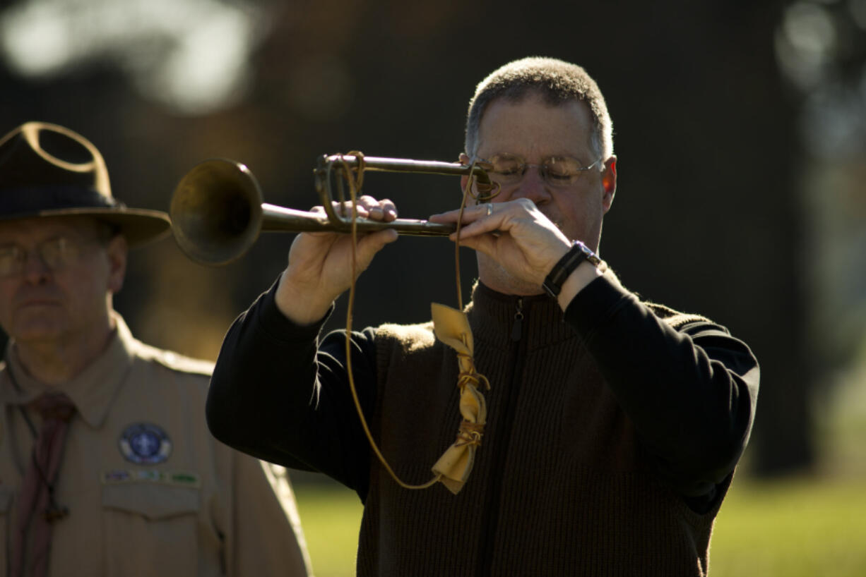 Bugle player Greg Garrett of Vancouver plays taps during a commemoration of the armistice ending World War I at the Fort Vancouver parade grounds Sunday.