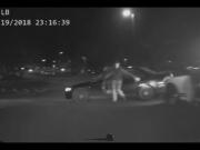 A still from a police car's dash camera video shows a suspect in a pursuit, Isaiah Gellatly of Vancouver, climb out of his moving vehicle while fleeing pursuing police officers Monday night in Happy Valley, Ore. Gellatly's leg was pinned under one of the car's tires, and he was arrested and brought to a hospital with a broken leg once officials got him out.