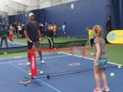 James Blake hit tennis balls with kids during a community event at the Vancouver Tennis Center on Saturday, Nov. 3, 2018.