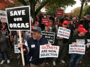 Members of the Coastal Conservation Association protest outside a bi-state fish and wildlife commission meeting on Nov. 1 at the Heathman Lodge in Vancouver. The states are considering dropping a policy that removes commercial gill nets from the Columbia River.