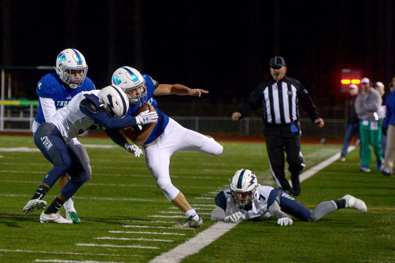 Mountain View running back Jack Mertens breaks tackles to stay in bounds against Squalicum at McKenzie Stadium on Saturday night, November 11, 2018. Mountain View crushed Squalicum 42-0 in the first round of the 3A state football playoffs.