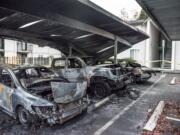 Cars damaged in an early morning car fire are seen here at the Meadow Wood Apartments on Wednesday morning,  Nov. 14, 2018.