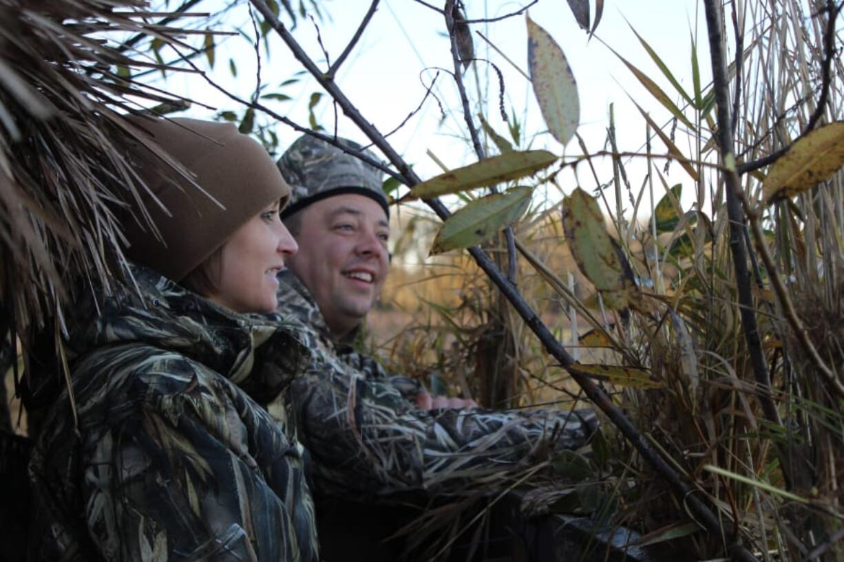 Jennifer and Douglas Hawkins search the sky for ducks as they take part in the first Ridgefield National Wildlife Refuge Veterans Waterfowl Hunt. The couple have a combined 32 years of military service.