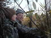 Jennifer and Douglas Hawkins search the sky for ducks as they take part in the first Ridgefield National Wildlife Refuge Veterans Waterfowl Hunt. The couple have a combined 32 years of military service.