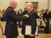 Fifty years after Ret. Marine 1st Sgt. John Lord, right, led his platoon through an ambush in the Vietnam War, he is presented with the Navy Cross by  Col. Jay Wylie at the Marine Corps Birthday Ball at the Hilton Vancouver Washington on Saturday.