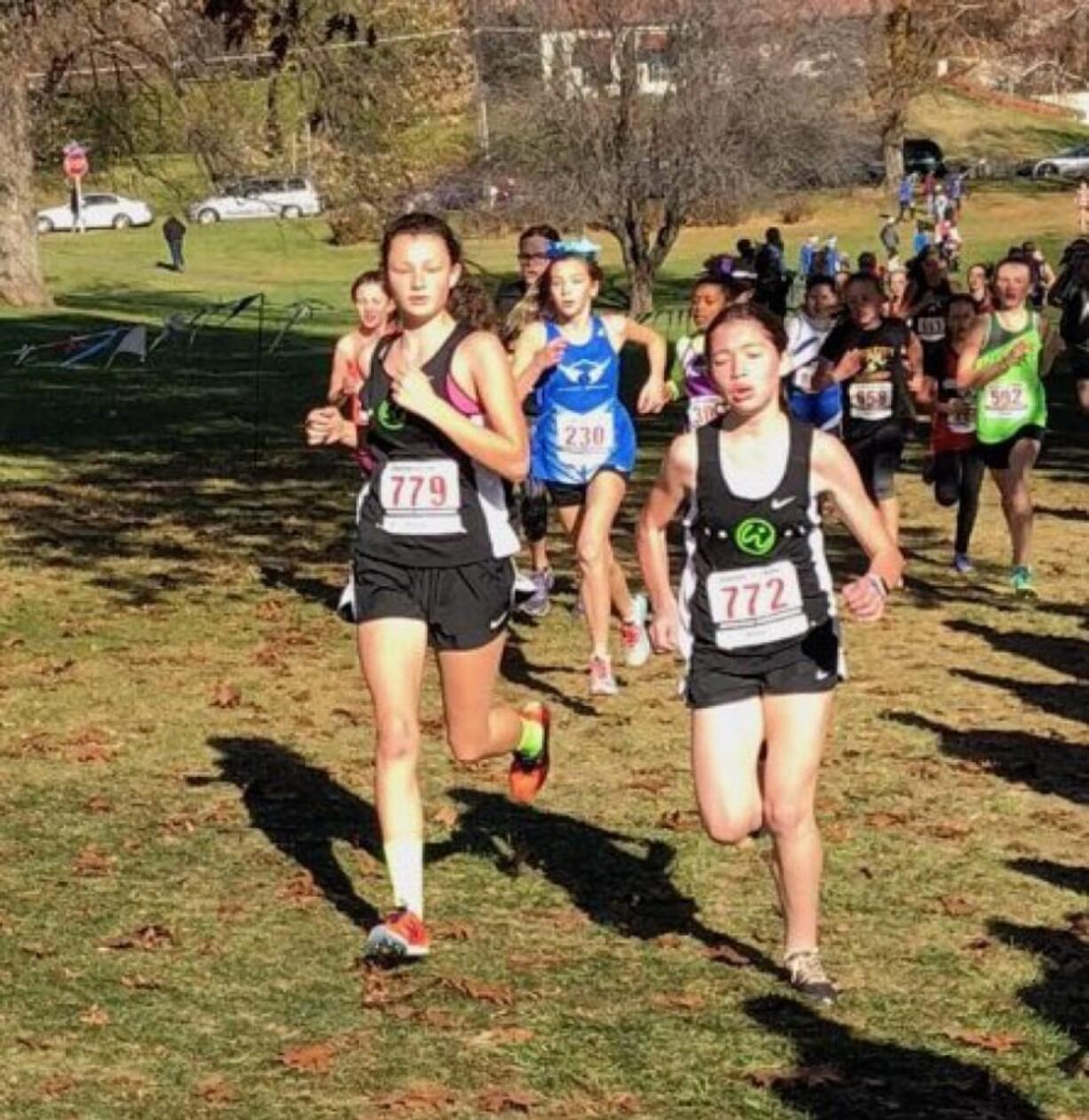 Abigail Rounds, left, and Addison Crum compete in the 11-12 age group race at the USATF Junior Olympic Regional cross country meet Saturday in Yakima. They run for Vancouver-based Whisper Running, which qualified 21 runners for Nationals next month in Reno, Nevada. (Photo courtesy of Dave Caldwell).