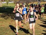 Abigail Rounds, left, and Addison Crum compete in the 11-12 age group race at the USATF Junior Olympic Regional cross country meet Saturday in Yakima. They run for Vancouver-based Whisper Running, which qualified 21 runners for Nationals next month in Reno, Nevada. (Photo courtesy of Dave Caldwell).