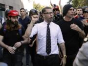 Gavin McInnes, center, founder of the far-right group the Proud Boys, is surrounded by supporters after speaking at a rally in Berkeley, Calif., in April 2017.