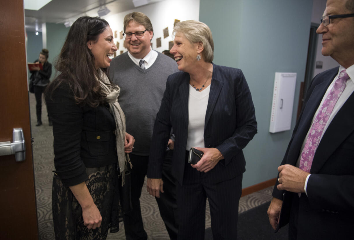 Alishia Topper, left, discusses election results with other candidates Nov. 7 at the Public Service Center.