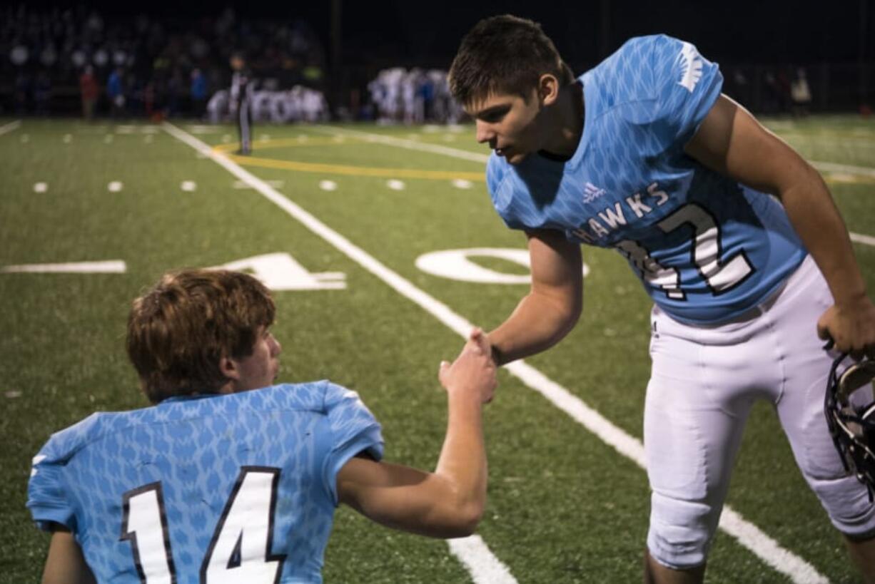 Hockinson’s Levi Crum (14) and Jon Domingos (42) encourage each another before the first round of the 2A state football playoffs against Washington.