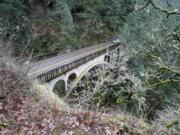 Shepperd’s Dell bridge crosses a small canyon in the Columbia River Gorge near Bridal Veil, Ore., along the Historic Columbia River Highway Tuesday, Jan. 26, 2010. The dell was carved by a creek that includes two fairly substantial tumbling waterfalls. The highway is a winding road amidst lush green trees and cascading waterfalls, overlooks that provide views of the Columbia River.