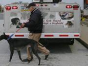 National Greyhound Adoption Program volunteer Tony Tereszcuk receives five greyhounds from the Canidrome racetrack in Macau, China.