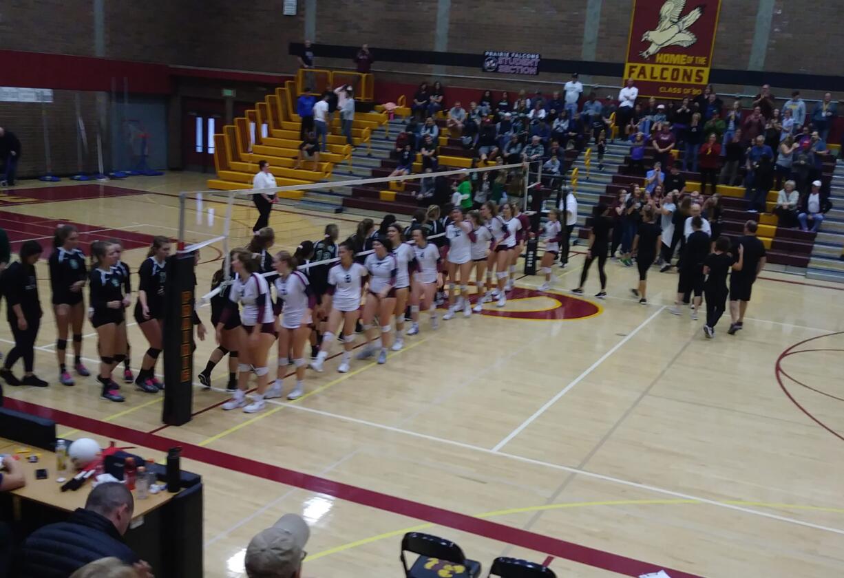 Prairie volleyball players shake hands with their counterparts from Peninsula after Prairie beat the Seahawks 3-1 (Tim Martinez/The Columbian)