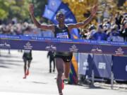 Lelisa Desisa, of Ethiopia, crosses the finish line first in the men's division of the New York City Marathon in New York, Sunday, Nov. 4, 2018.