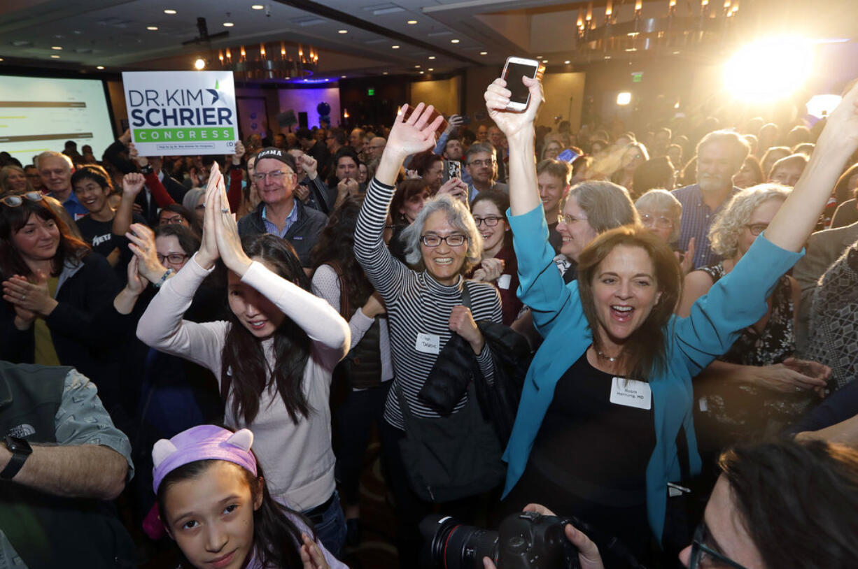 Supporters cheer Congressional candidate Kim Schrier as she addresses the crowd at an election night party for Democrats Tuesday, Nov. 6, 2018, in Bellevue, Wash.