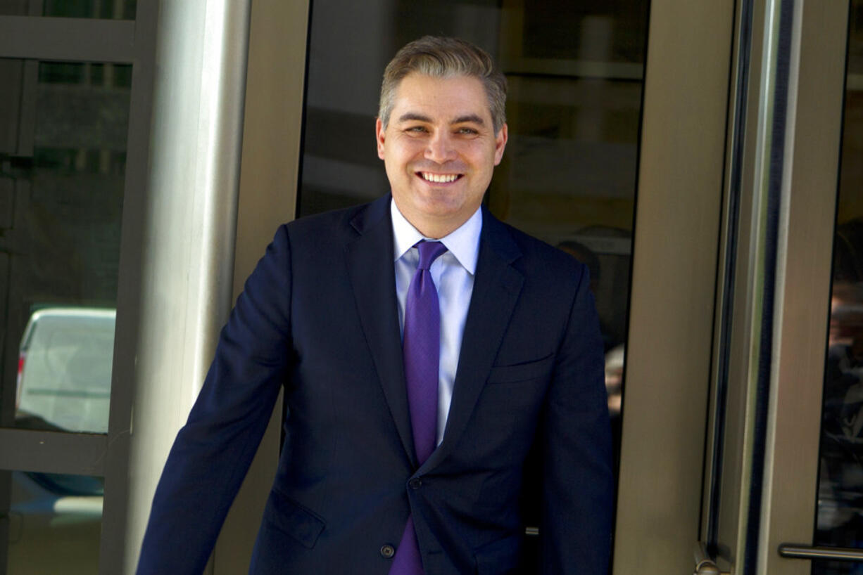 CNN's Jim Acosta walks out of the U.S. District Courthouse with a smile, Friday, Nov. 16, 2018, in Washington.  U.S. District Court Judge Timothy Kelly ordered the White House to immediately return Acosta’s credentials. He found that Acosta was “irreparably harmed” and dismissed the government’s argument that CNN could send another reporter in Acosta’s place to cover the White House.