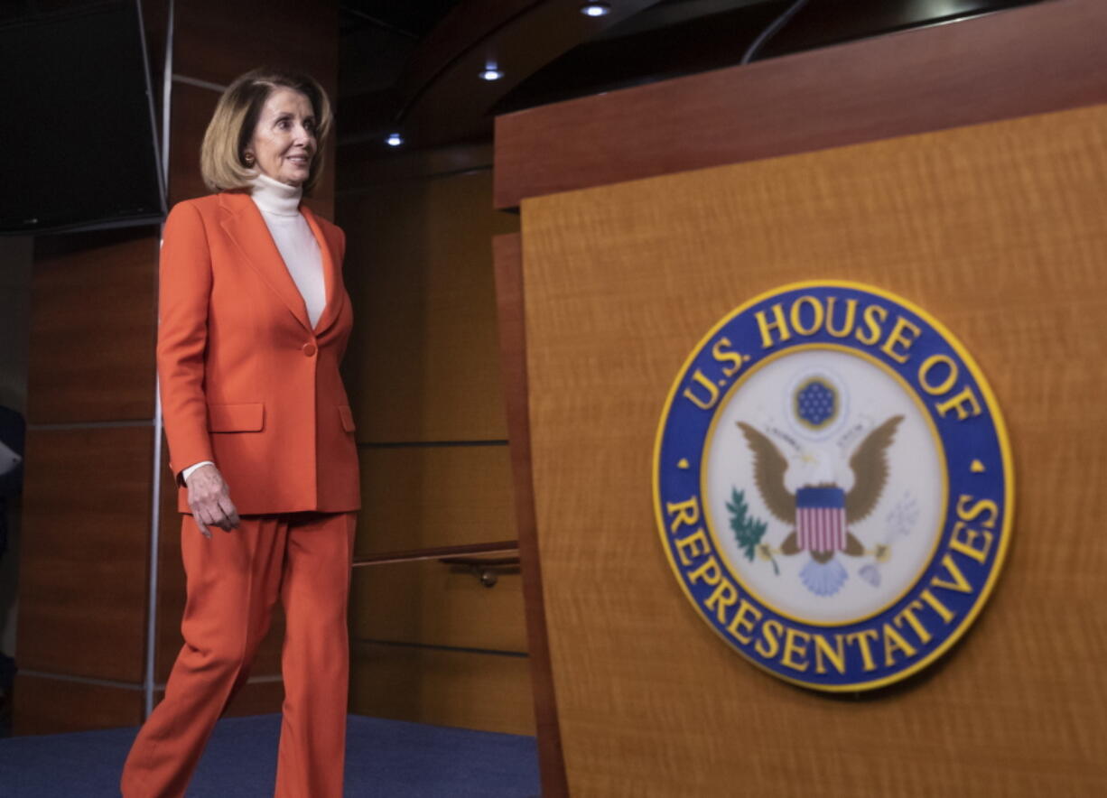 House Minority Leader Nancy Pelosi, D-Calif., arrives to face reporters at a news conference at the Capitol in Washington. (AP Photo/J.