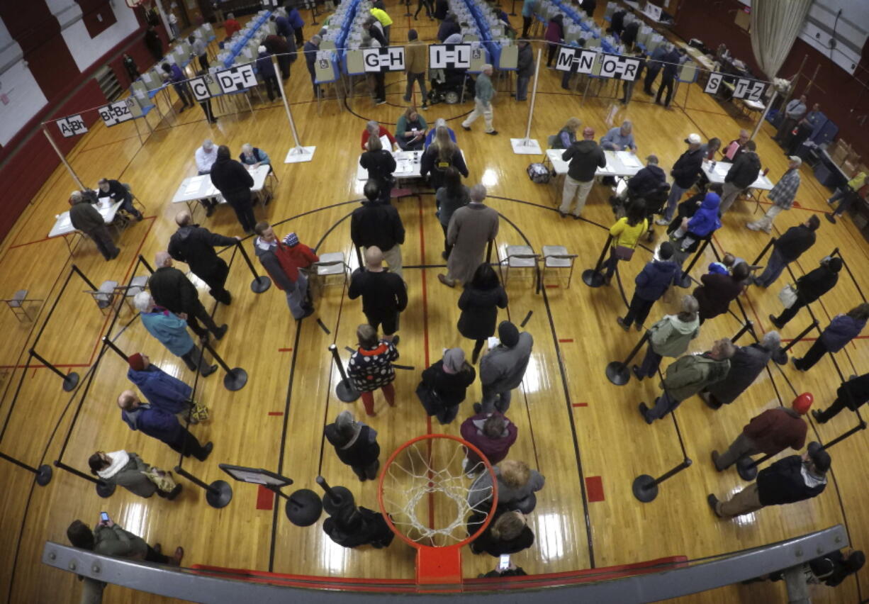 Voters wait in line in the gymnasium at Brunswick Junior High School to receive their ballots for the mid-term election Tuesday in Brunswick, Maine. (AP Photo/Robert F.