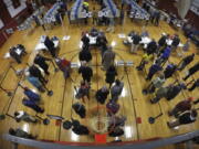 Voters wait in line in the gymnasium at Brunswick Junior High School to receive their ballots for the mid-term election Tuesday in Brunswick, Maine. (AP Photo/Robert F.