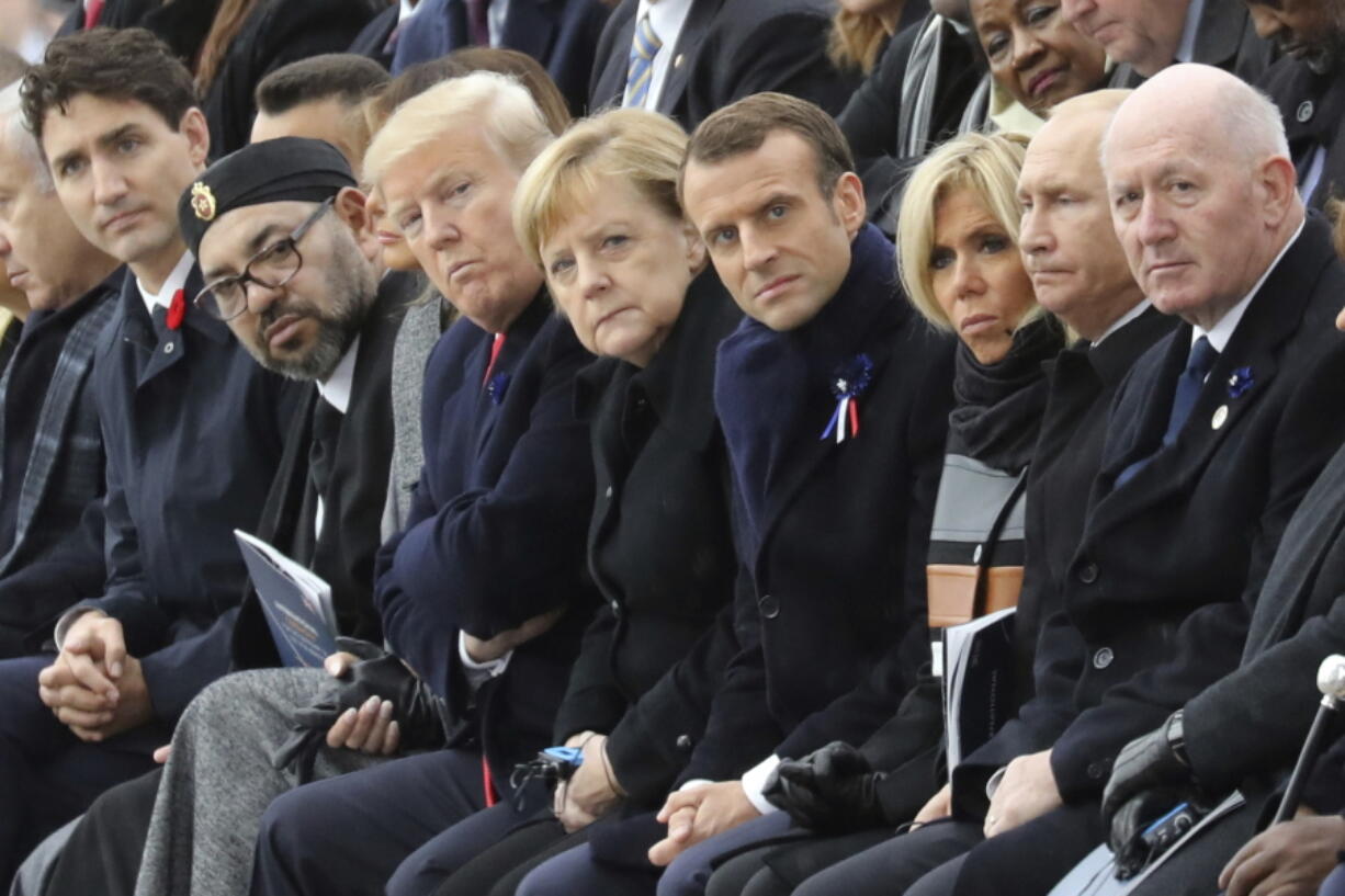 From left, Canadian Prime Minister Justin Trudeau, Morocco’s Prince Moulay Hassan, Moroccan King Mohammed VI, US First Lady Melania Trump, US President Donald Trump, German Chancellor Angela Merkel, French President Emmanuel Macron and his wife Brigitte Macron, Russian President Vladimir Putin and Australian Governor-General Peter Cosgrove attend a ceremony Sunday at the Arc de Triomphe in Paris, France, as part of the commemorations marking the 100th anniversary of the 11 November 1918 armistice, ending World War I.