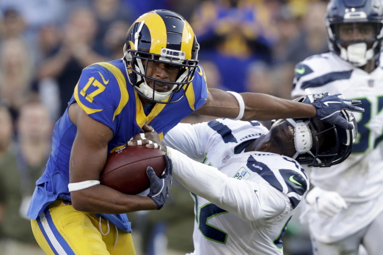 Los Angeles Rams wide receiver Robert Woods, left, pushes away Seattle Seahawks defensive back Delano Hill during the second half in an NFL football game Sunday, Nov. 11, 2018, in Los Angeles.