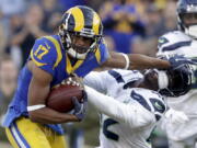 Los Angeles Rams wide receiver Robert Woods, left, pushes away Seattle Seahawks defensive back Delano Hill during the second half in an NFL football game Sunday, Nov. 11, 2018, in Los Angeles.