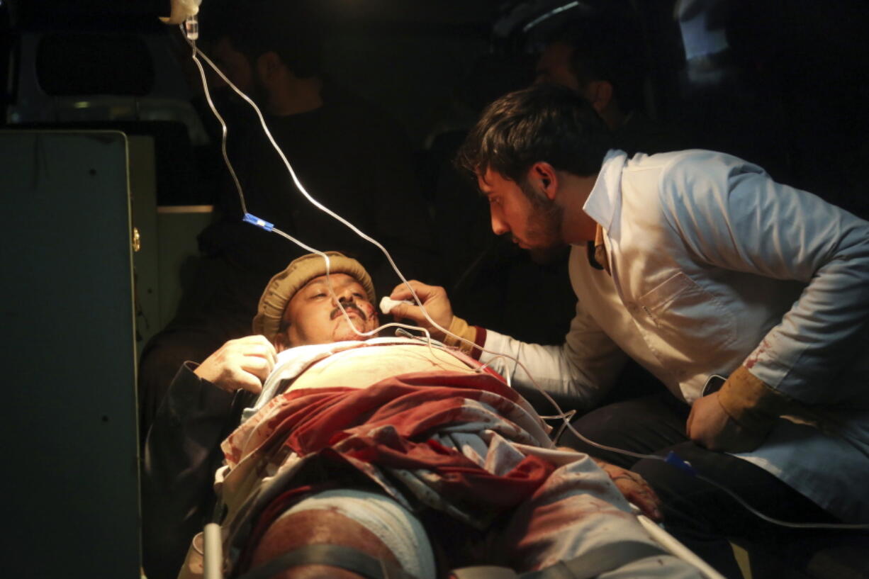 An injured man receives treatment in an ambulance after a suicide attack in Kabul, Afghanistan. The United Nations Assistance Mission in Afghanistan said in a new report released Tuesday, Nov. 6, 2018, that 56 civilians were killed and 379 others wounded in attacks during the recent parliamentary election. The numbers reveal that more civilians were harmed in this year’s election violence than in four previous Afghanistan national elections.