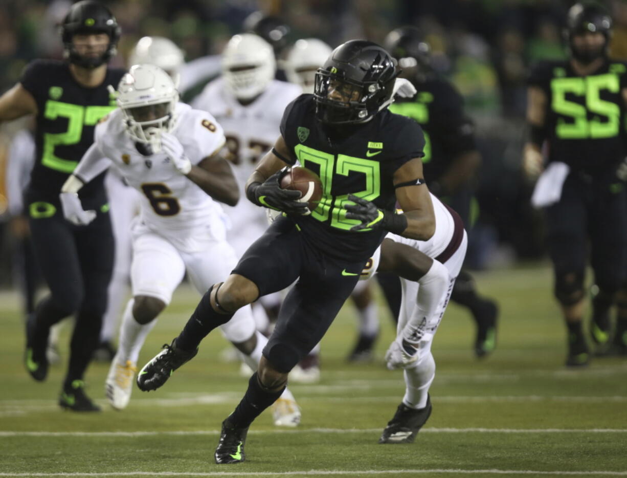 Oregon’s CJ Verdell, center, breaks through the Arizona State defense during the second quarter of an NCAA college football game Saturday, Nov. 17, 2018, in Eugene, Ore.