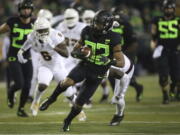 Oregon’s CJ Verdell, center, breaks through the Arizona State defense during the second quarter of an NCAA college football game Saturday, Nov. 17, 2018, in Eugene, Ore.