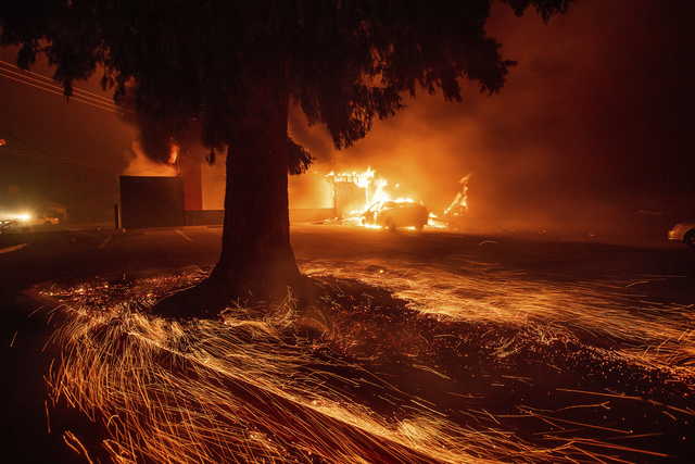 Flames consume a Kentucky Fried Chicken as the Camp Fire tears through Paradise, Calif., on Thursday, Nov. 8, 2018. Tens of thousands of people fled a fast-moving wildfire Thursday in Northern California, some clutching babies and pets as they abandoned vehicles and struck out on foot ahead of the flames that forced the evacuation of an entire town and destroyed hundreds of structures.