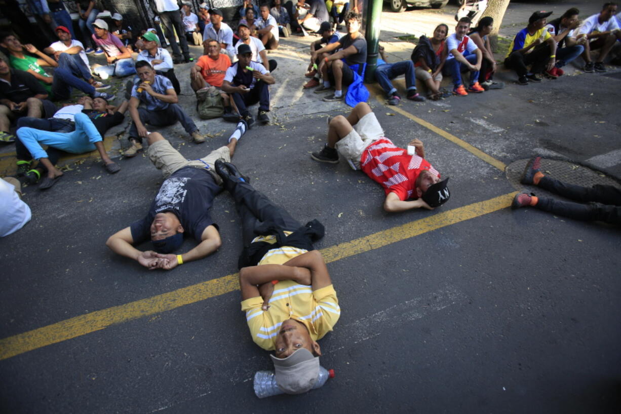 Scores of Central American migrants, representing the thousands participating in a caravan trying to reach the U.S. border, rest in front of the office of the United Nation’s human rights body, after undertaking an hours-long march to demand buses, in Mexico City, Thursday, Nov. 8, 2018. Members of the caravan which has stopped in Mexico City demanded buses to take them to the U.S.