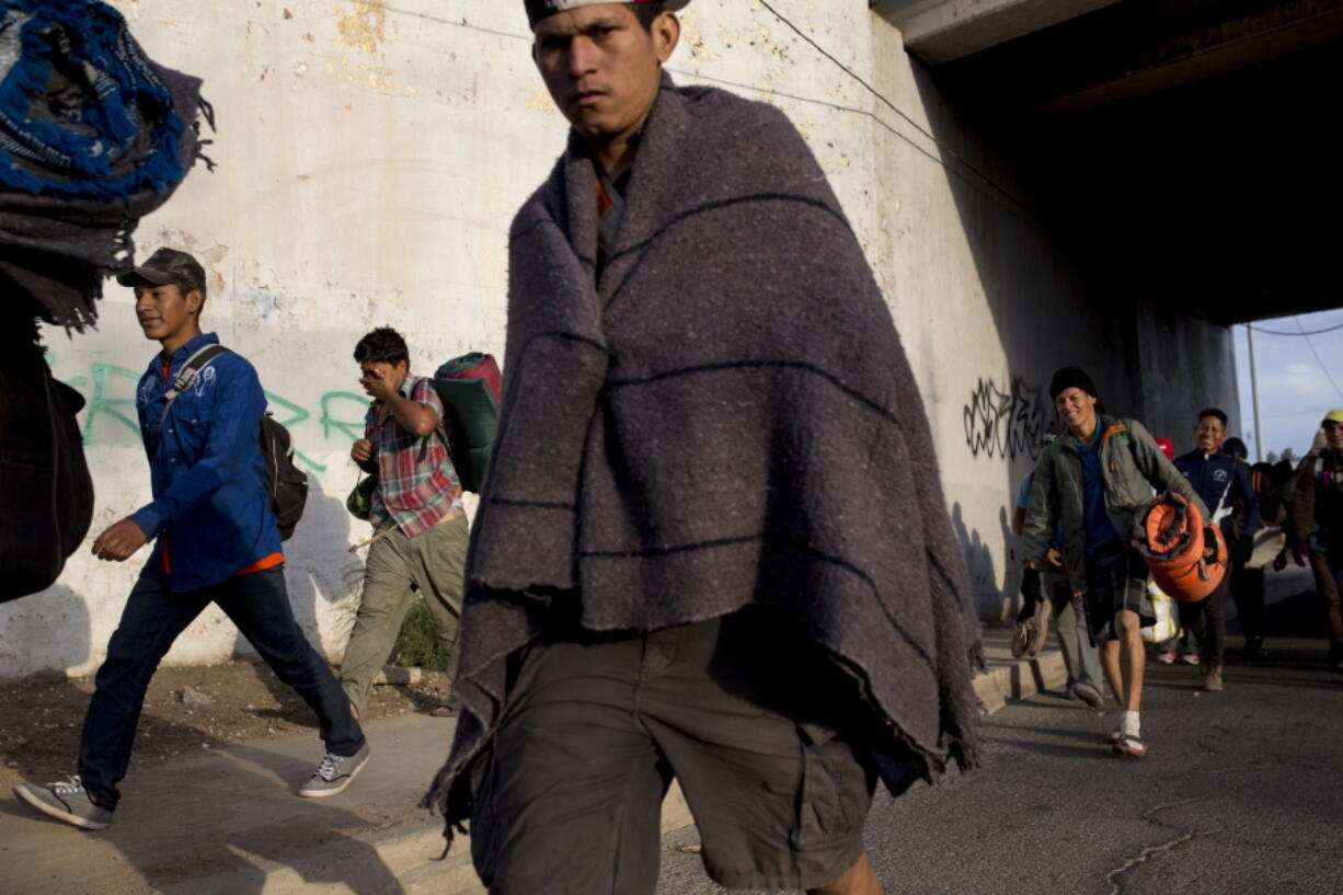 Central American migrants, part of the Central American caravan trying to reach the United States, continue their journey as they leave Mexicali, Mexico, Tuesday, Nov. 20, 2018. Tensions have built as nearly 3,000 migrants from the caravan poured into Tijuana in recent days after more than a month on the road, and with many more months likely ahead of them while they seek asylum in the U.S.