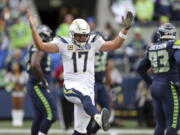 Los Angeles Chargers quarterback Philip Rivers celebrates a touchdown by the team against the Seattle Seahawks during the first half of an NFL football game, Sunday, Nov. 4, 2018, in Seattle.