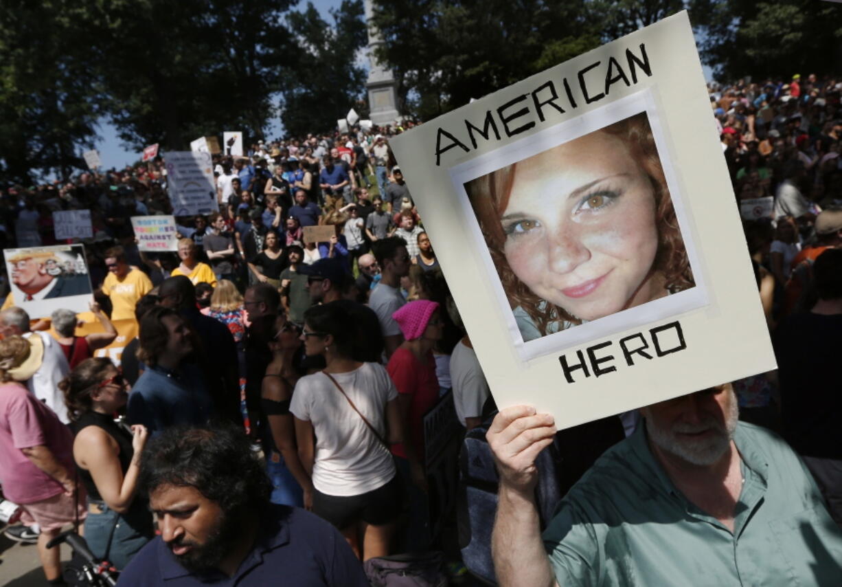 A counter-protester holds a photo of Heather Heyer on Boston Common at a “Free Speech” rally organized by conservative activists, in Boston. Jury selection is set to begin in the trial of James Alex Fields Jr., accused of killing Heyer during a white nationalist rally in Charlottesville in 2017. His trial is scheduled to begin Monday, Nov. 26, 2018, in Charlottesville Circuit Court.