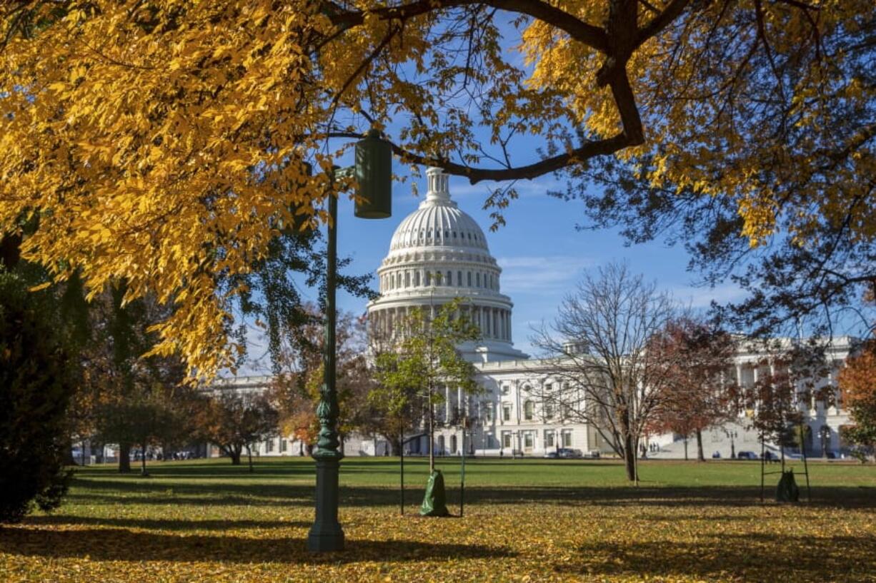 In this Nov. 8, 2018 photo, the Capitol is framed amid colorful autumn leaves in Washington. Congressional aides and advocacy groups say lawmakers are close to an agreement on legislation designed to boost rehabilitation efforts for federal prisoners and give judges more discretion when sentencing some non-violent offenders. Aides from both parties say moving ahead depends largely on President Donald Trump. (AP Photo/J.