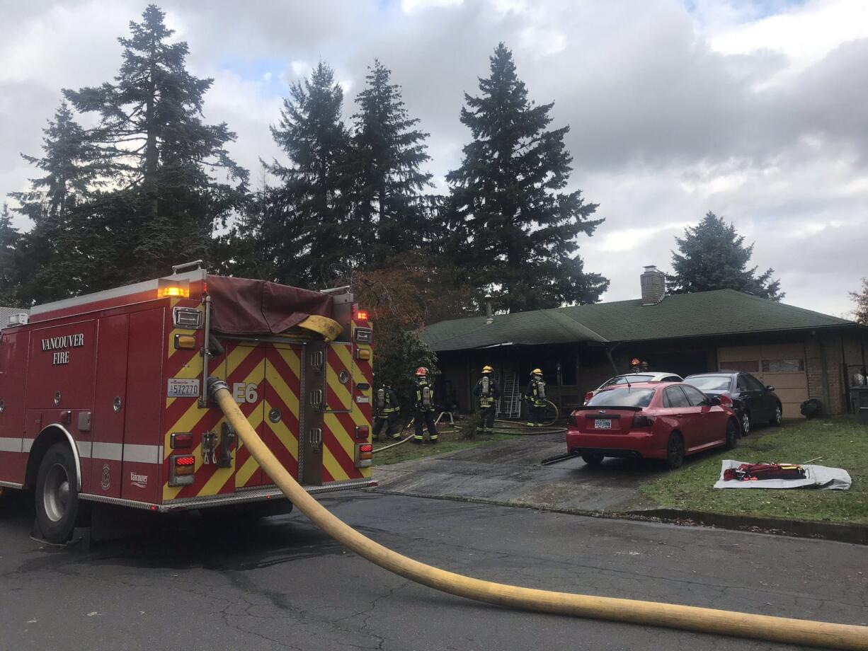 Vancouver firefighters attack a fire at a home in the Ogden neighborhood Thursday afternoon.