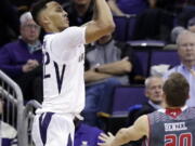 Washington’s Dominic Green shoots over Eastern Washington’s Cody Benzel (20) in the second half of an NCAA college basketball game Tuesday, Nov. 27, 2018, in Seattle. Green lead all scorers with 25 points and Washington won 83-59.