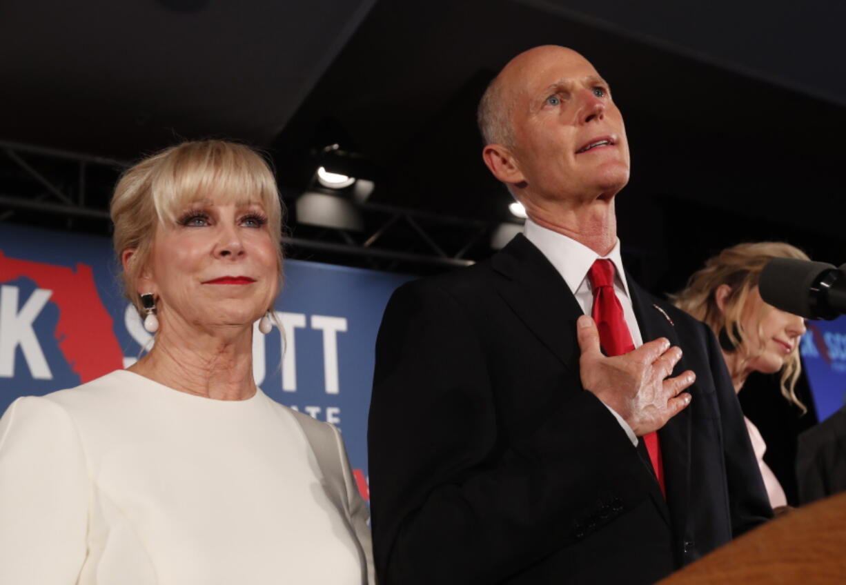 FILE- In this Wednesday, Nov. 7, 2018, file photo Republican Senate candidate Rick Scott speaks with his wife Ann by his side at an election watch party in Naples, Fla. Scott is leading incumbent Sen. Bill Nelson in the state’s contentious Senate race. Official results posted by the state on Sunday, Nov. 18, showed Scott ahead of Nelson following legally-required hand and machine recounts. State officials will certify the final totals on Tuesday.